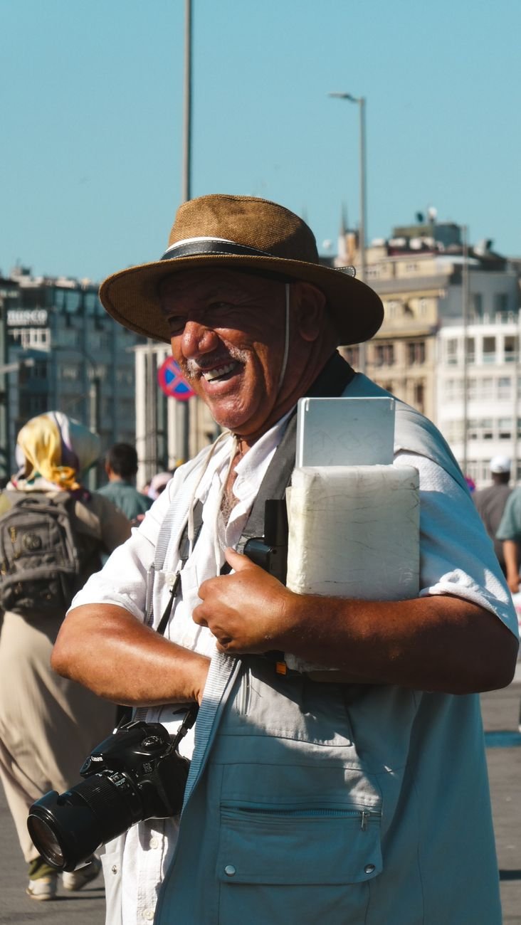 smiling man with camera in urban street